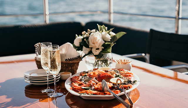 Seafood platter and champagne on the teak deck of Element Charters